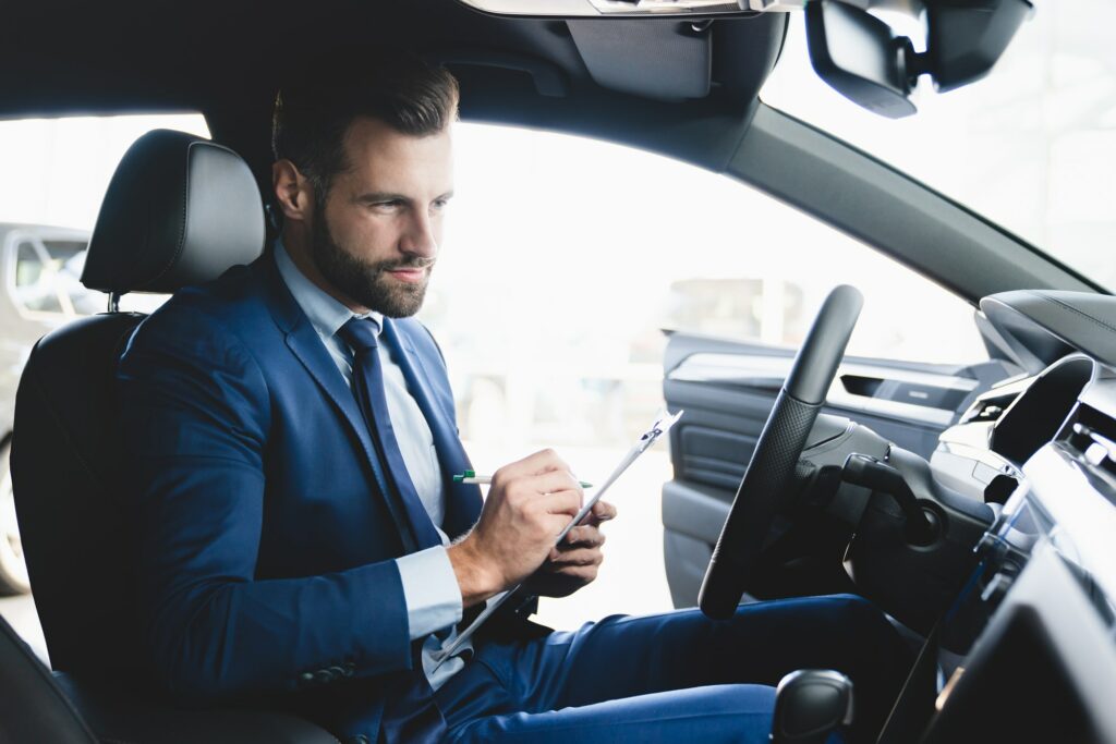 Taxi driver on the backseat with clients. Successful businessman husband looking at the backseat